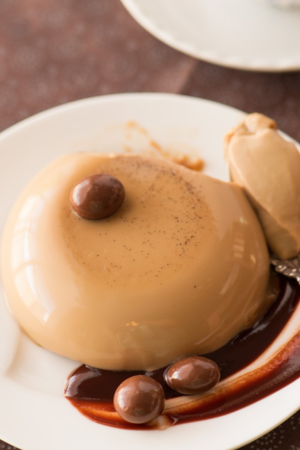 coffee and cream panna cotta with chocolate sauce and chocolate covered coffee beans